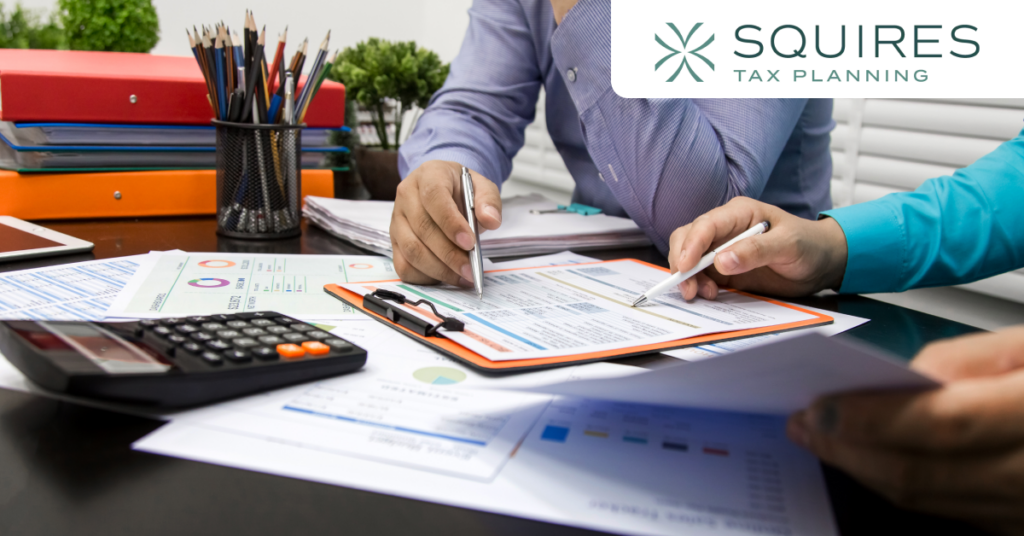 Small business owner reviewing payroll tax documents and tax reduction strategies.